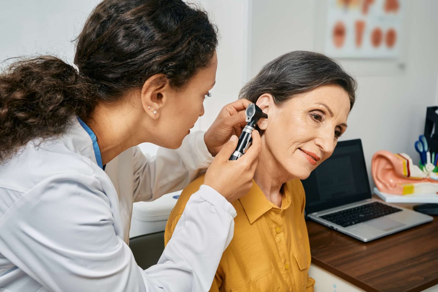 Woman getting her ears examined by a hearing specialist.