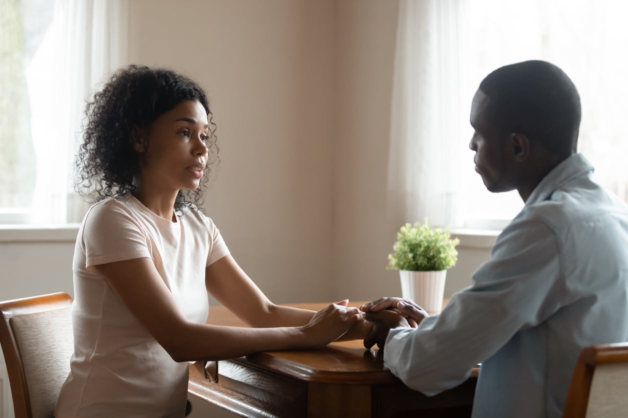 A couple holding hands and talking to each other