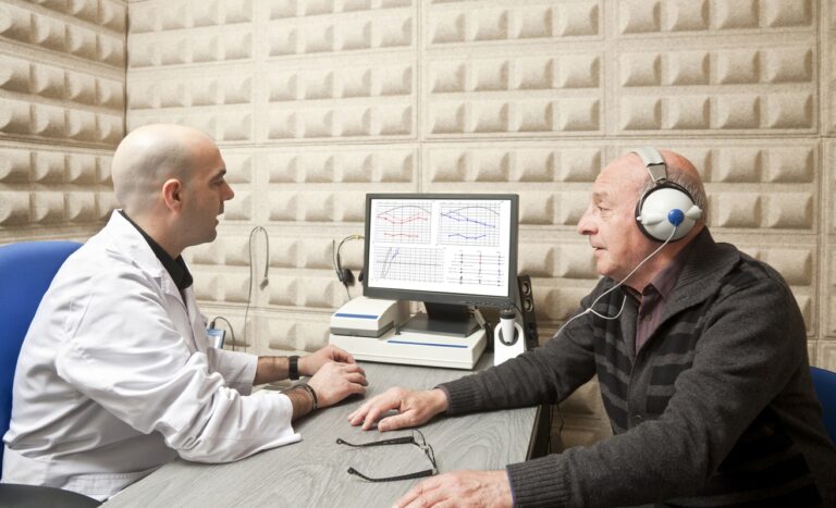 Man having his hearing tested at an audiology clinic Man having his hearing tested at an audiology clinic