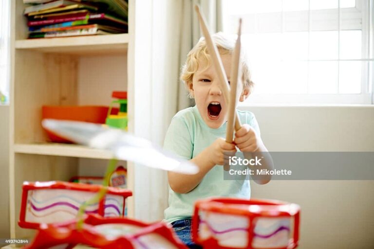 Child plays with loud drum Child plays with loud drum toy