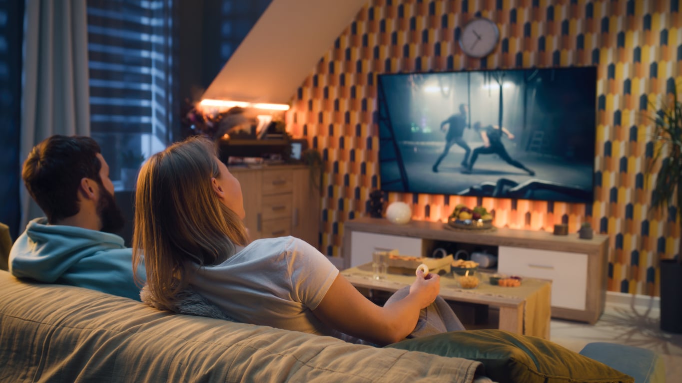 Couple watches action movie at home