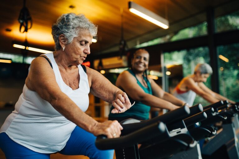 Group of senior women exercising together at the gym