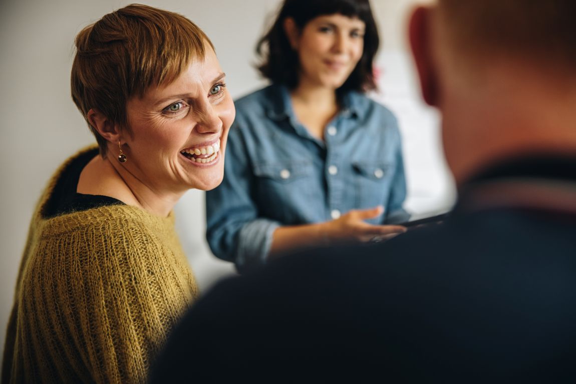 woman smiling in small group