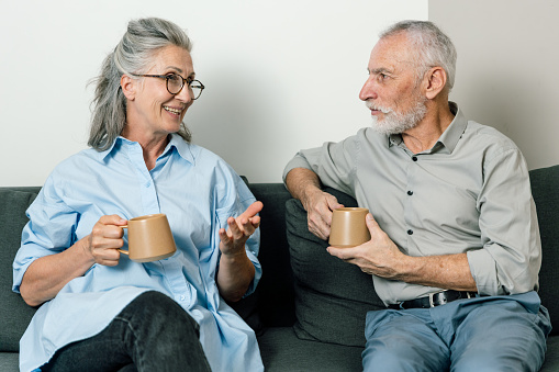 Two old friends catch up over coffee. Supportive friendships are an integral part of being human.
